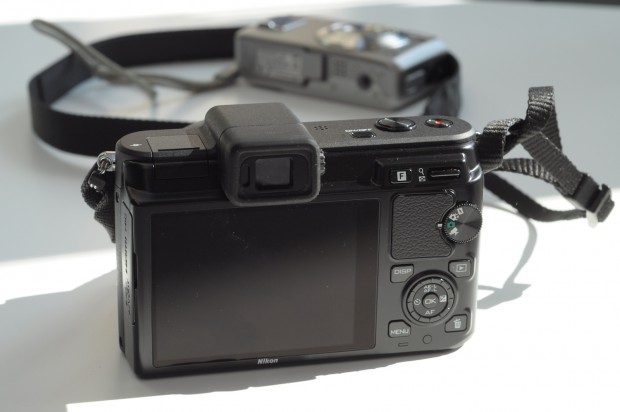 Die Rückseite bietet normale Kontrollen, wie eine Vier-Wege-Wippe, die gleichzeitig drehbar ist. Für das Rein- und Rauszoomen innerhalb bereits geschossener Bilder gibt es oben rechts eine Wippe.