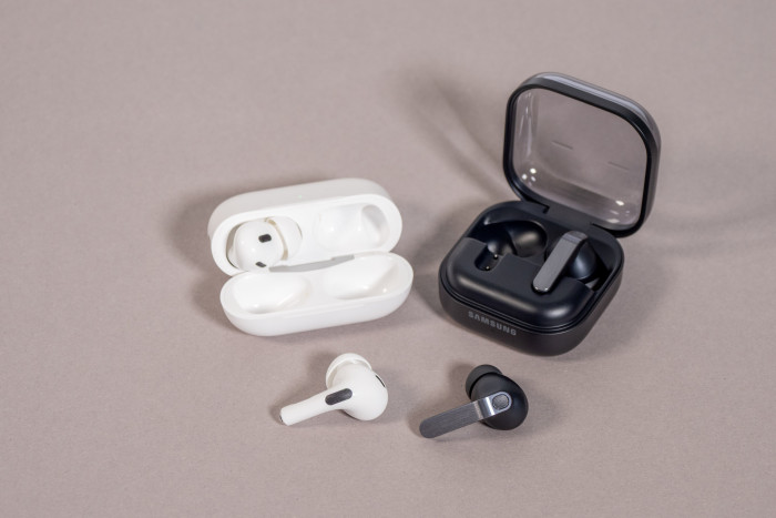 Links die Airpods Pro 2 im Ladeetui, rechts daneben die Galaxy Buds 4 Pro im Ladeetui (Bild: Martin Wolf/Golem)